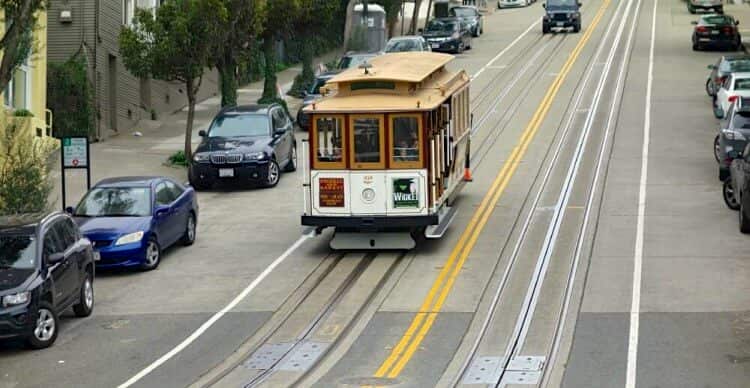 Cable car going down street