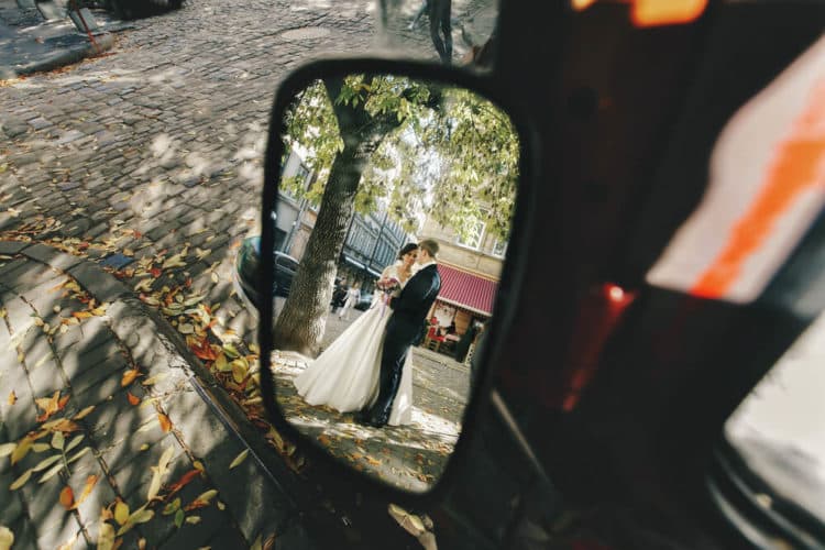 married couple reflection in rear view mirror of minibus