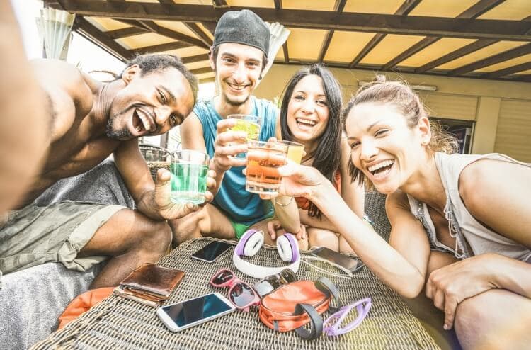 four friends enjoy drinks on a vacation