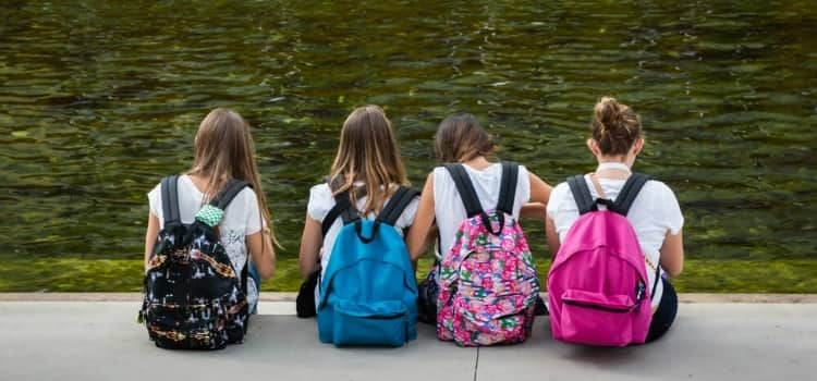 Four school girls sitting in a row