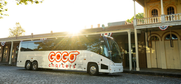 a white charter bus with a "gogo charters" logo on it