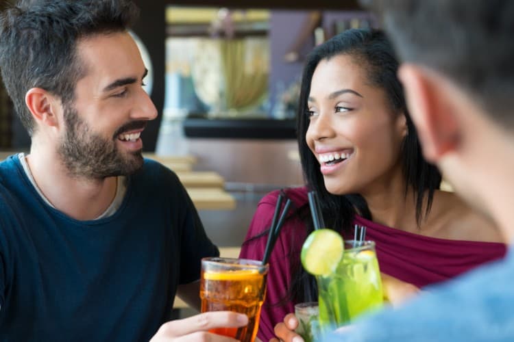 A group of colleagues toasting cocktails at happy hour 