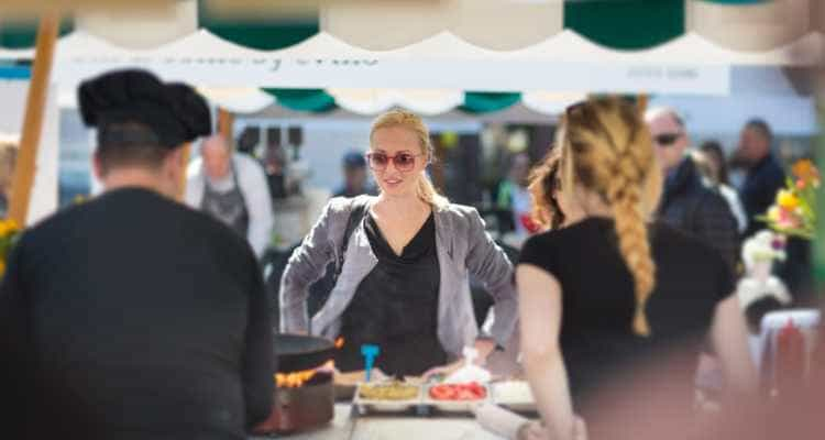 Woman standing at a food stand during Taste of Chicago