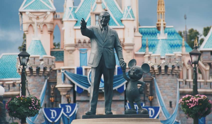 a statue of Walt Disney and Mickey Mouse at Disneyland