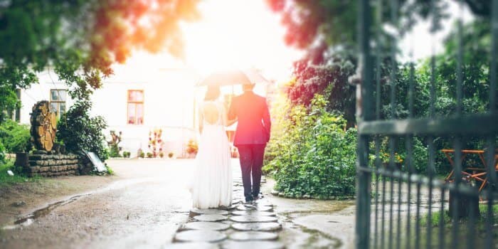 just married couple walking along a garden path