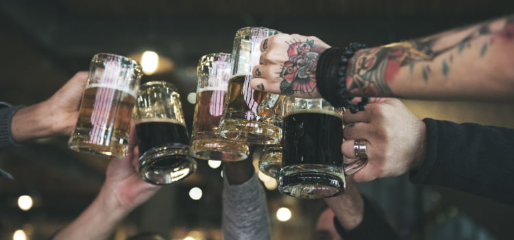 group of people toasting beers