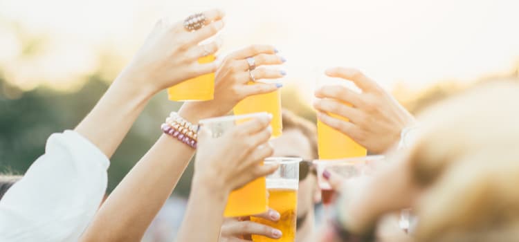 group holding beer up in a toast