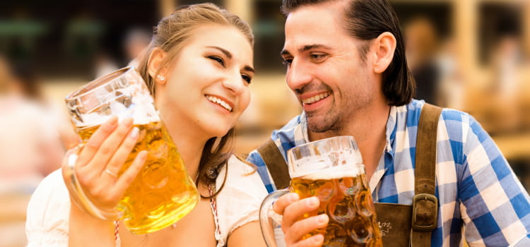 young couple drinking at oktoberfest