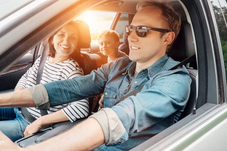 family driving together in a car