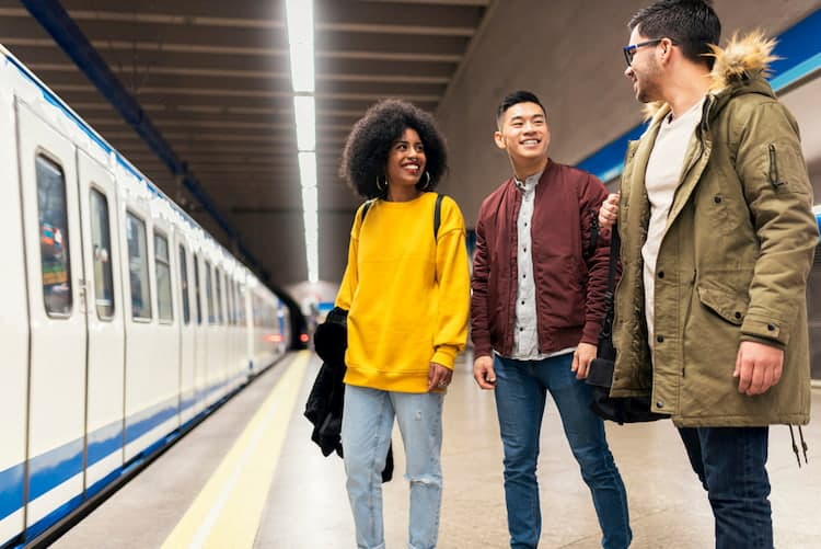 three friends waiting for a train