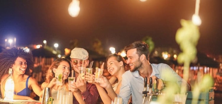 People enjoying mojitos together