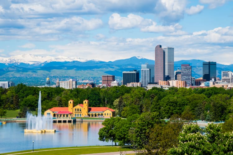 view of the Denver skyline in daylight, the Rockies visible in the background