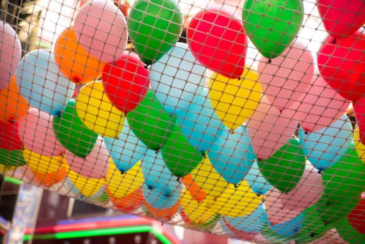 A net filled with balloons at a celebration.