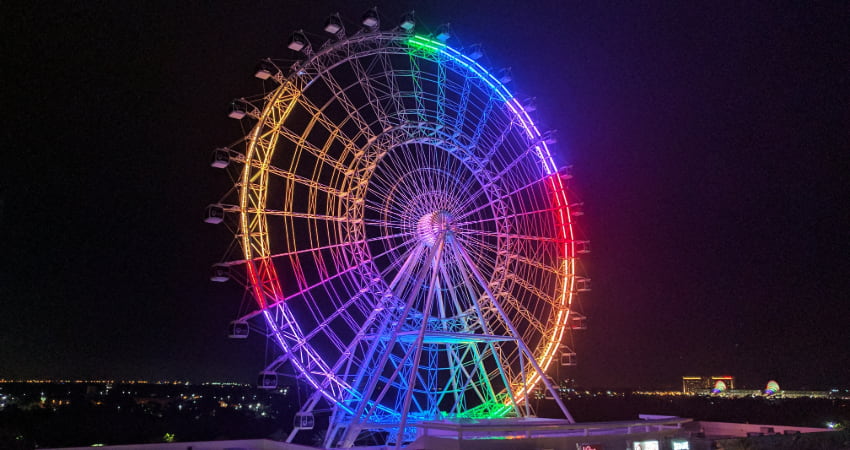 The Orlando Eye Ferris Wheel alight in rainbow colors on New Years Eve