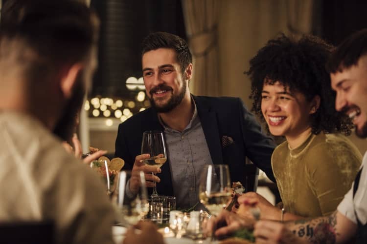 A group of people drinking wine and dining at a resturant