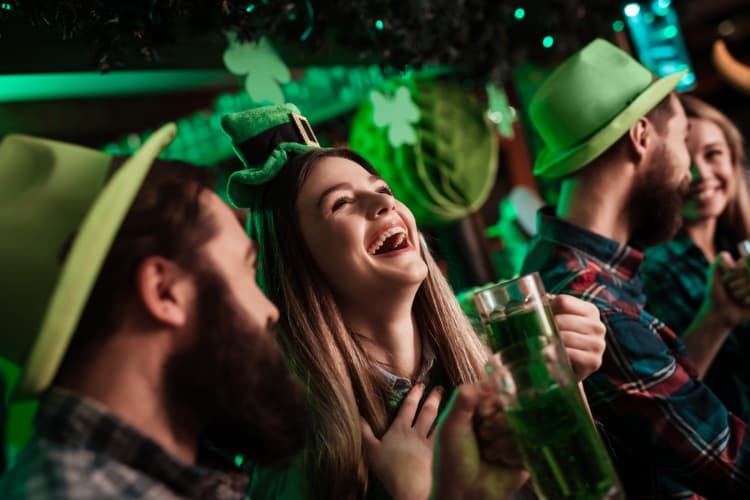 people laughing and drinking during saint patrick's day celebrations