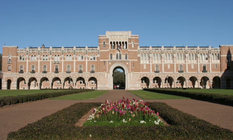 exterior of a Rice University building from the green space in front of it