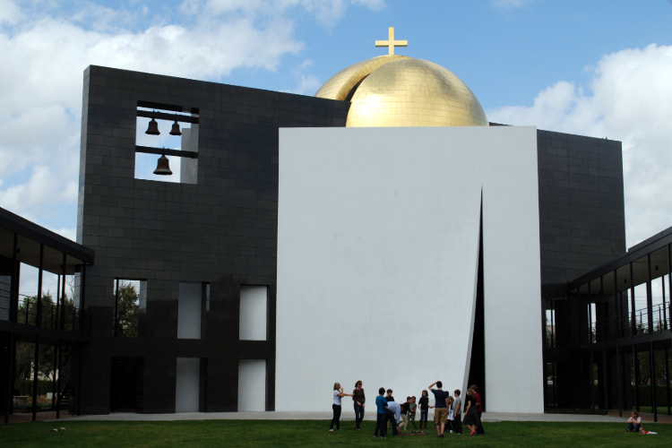 A campus tour group admires the Chapel of St. Basil at University of St. Thomas