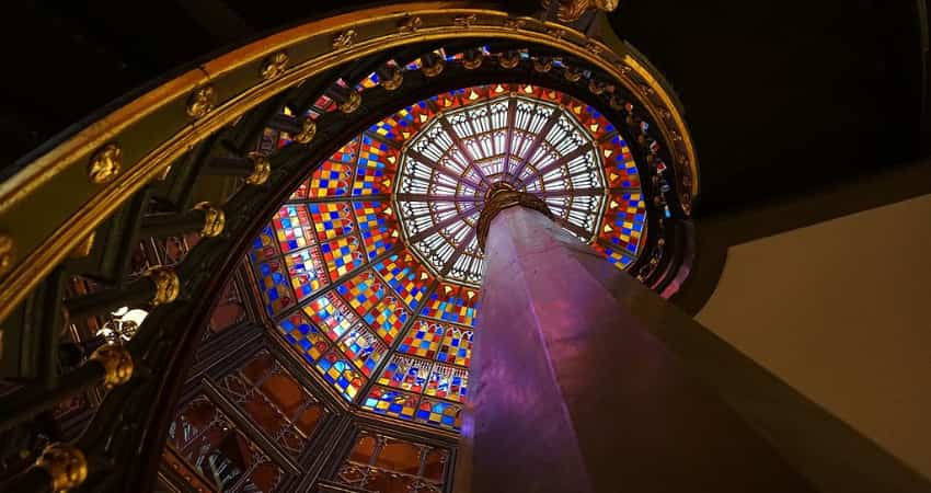 A spiral staircase leading up to the stained glass dome of Louisiana's Old State Capitol. 