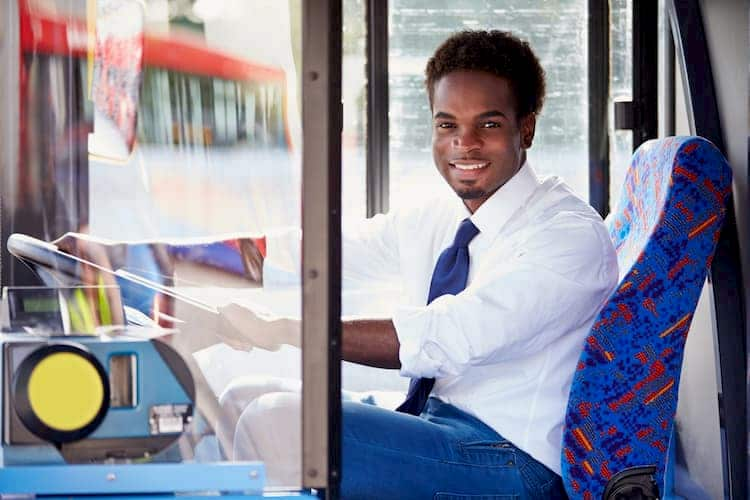 Man driving bus and smiling