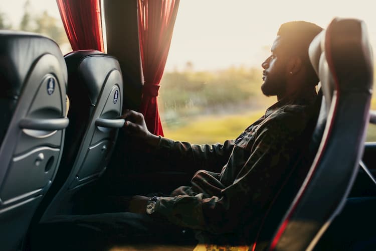 Man leaning back on charter bus