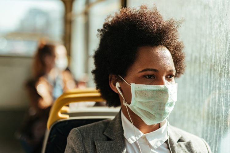 Woman wearing mask on bus