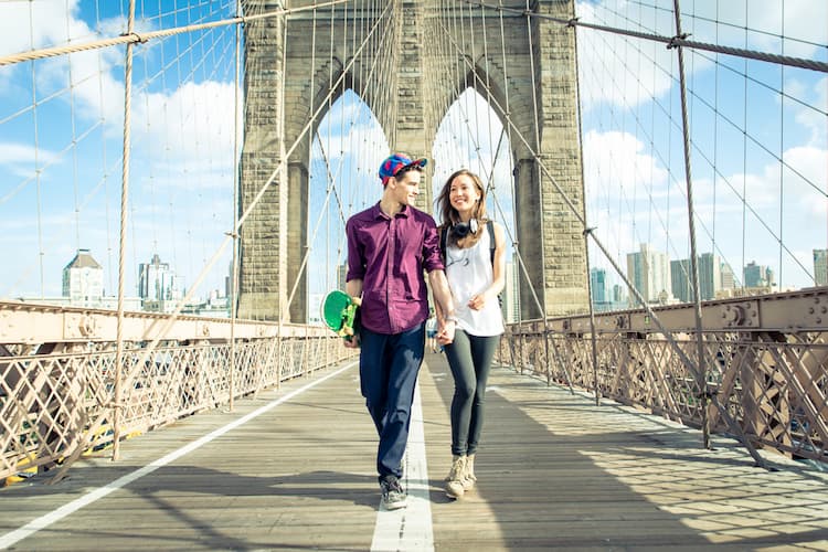 Couple walking on Brooklyn Bridge