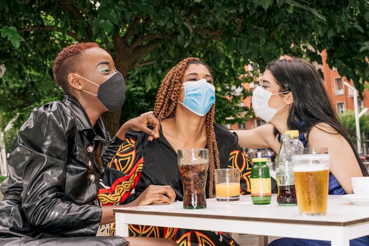 People with drinks in masks