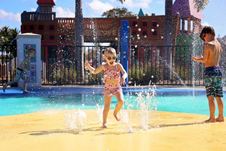 Kid playing in splash pads