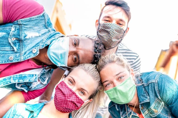 Friends smiling in masks