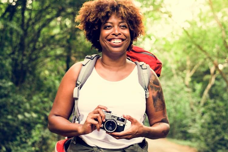 Woman hiking with camera