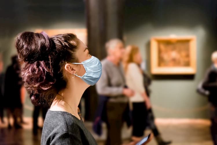 Woman wearing mask in museum