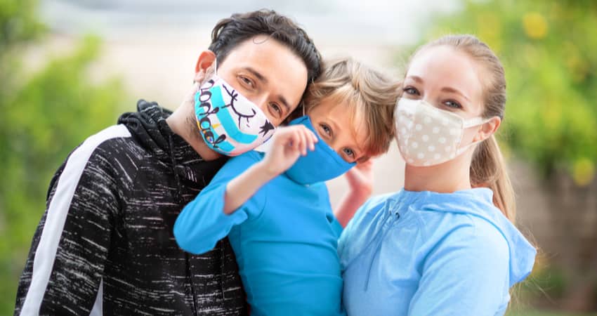 A close up of a family wearing masks