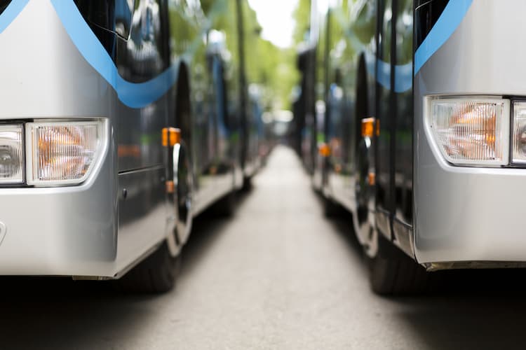 Two buses parked by side