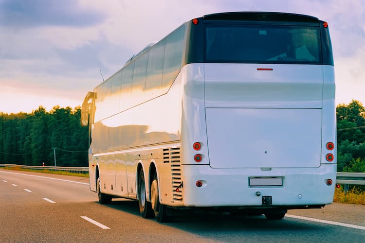 White charter bus on road