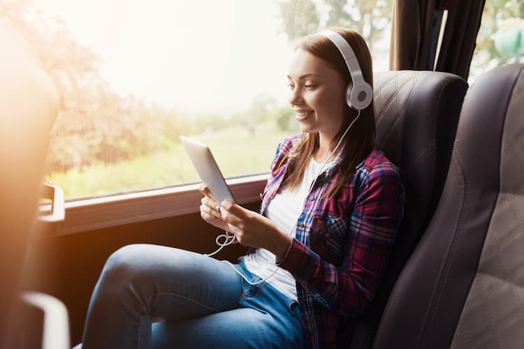 Woman looking at tablet on bus