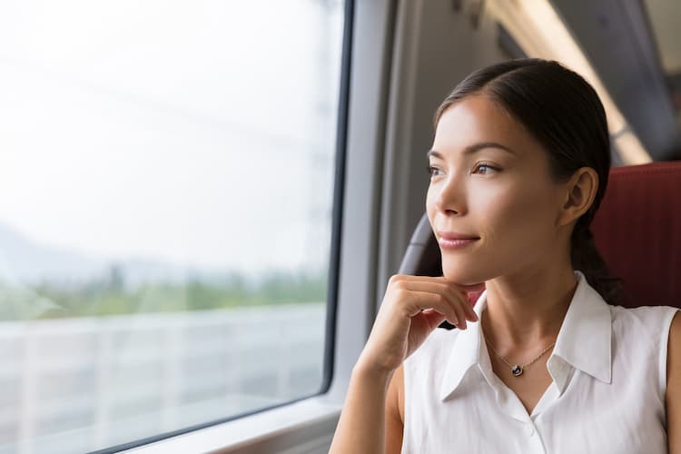 Woman looking out window on tour bus