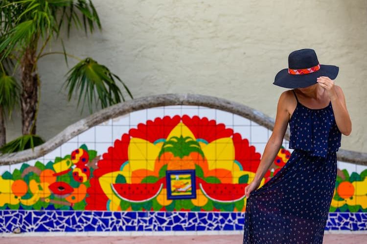 Woman posing in front of colorful wall in Little Havana