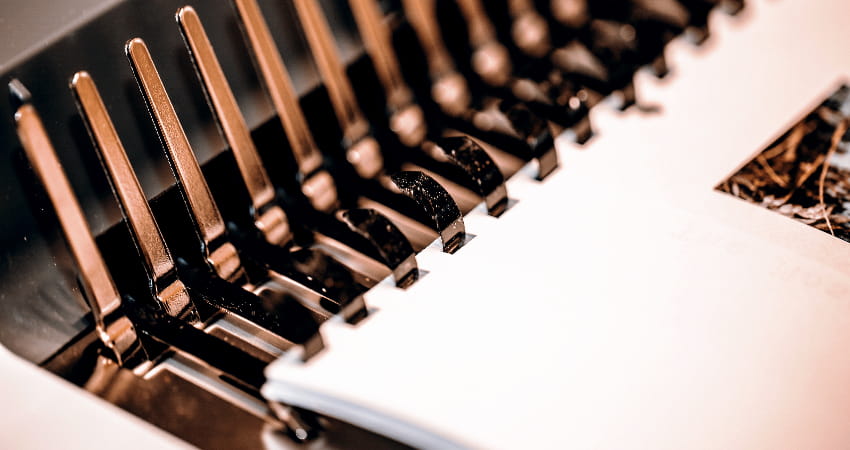 A closeup of a book binding machine