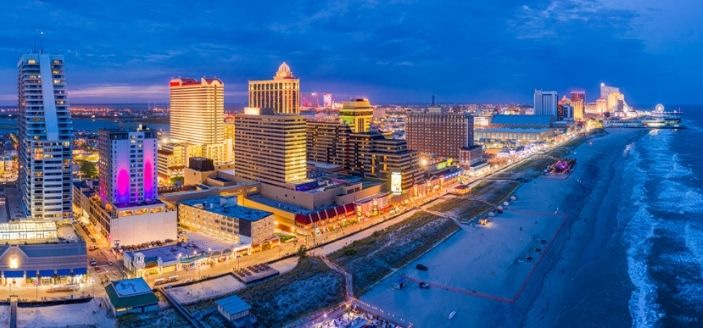 atlantic city casinos and boardwalk lit up at nigt