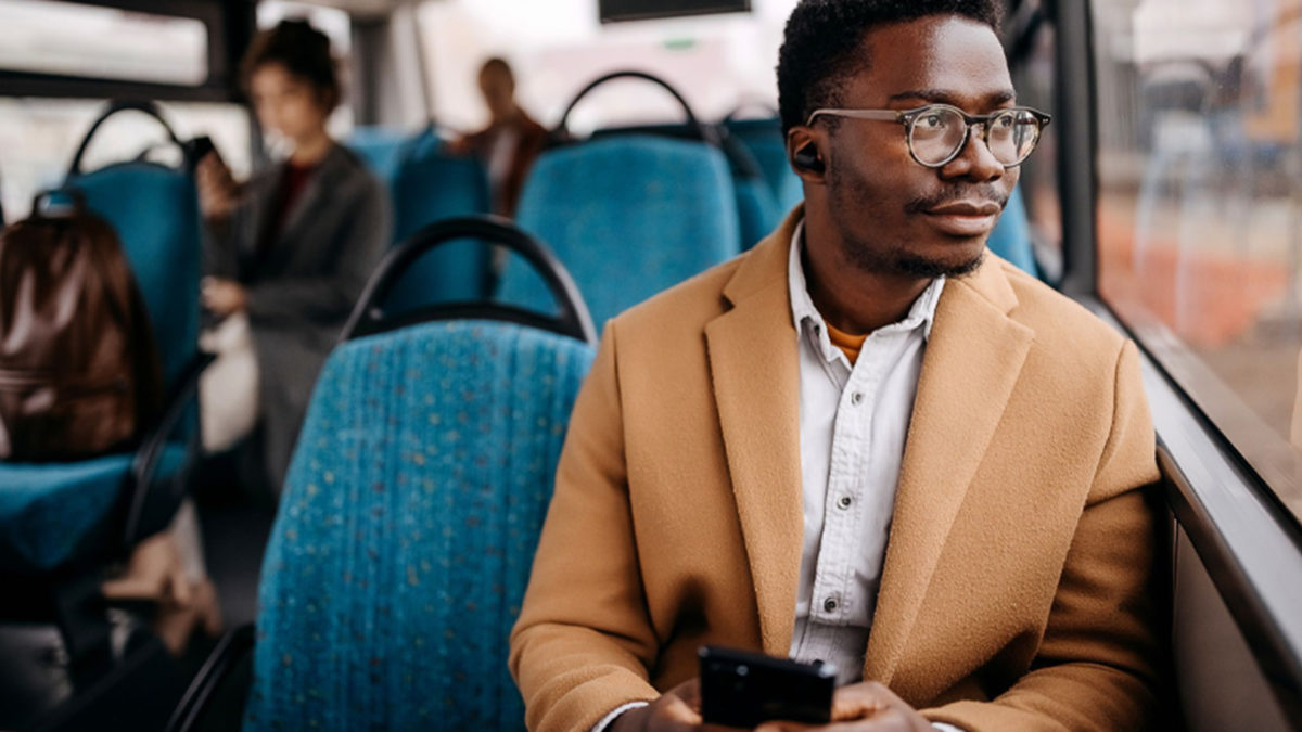 man looking out the window while riding the bus