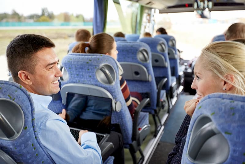 Man and woman talking on charter bus