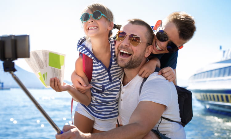 A family poses for a selfie before they board a cruise ship