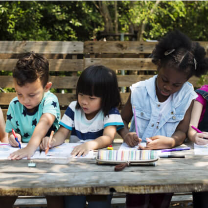children writing on an assignment during a field trip