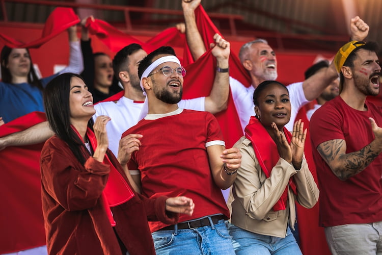 cheering fans wearing red at a sporting event