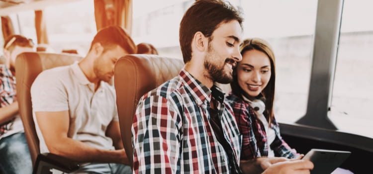 two friends ride in a comfortable charter bus seat