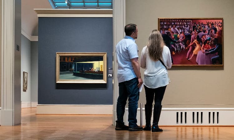 two people view a famous painting at the art institute