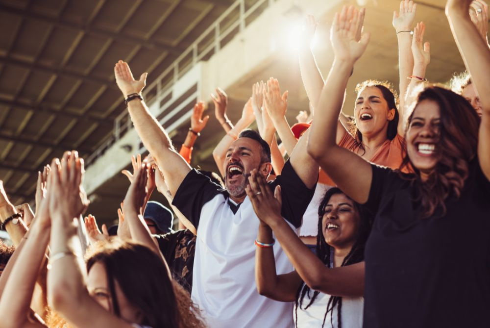 Sports fans cheering at a sporting event