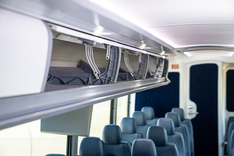 Interior overhead storage on a charter bus rental