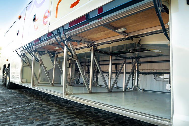 The undercarriage storage bay of a charter bus